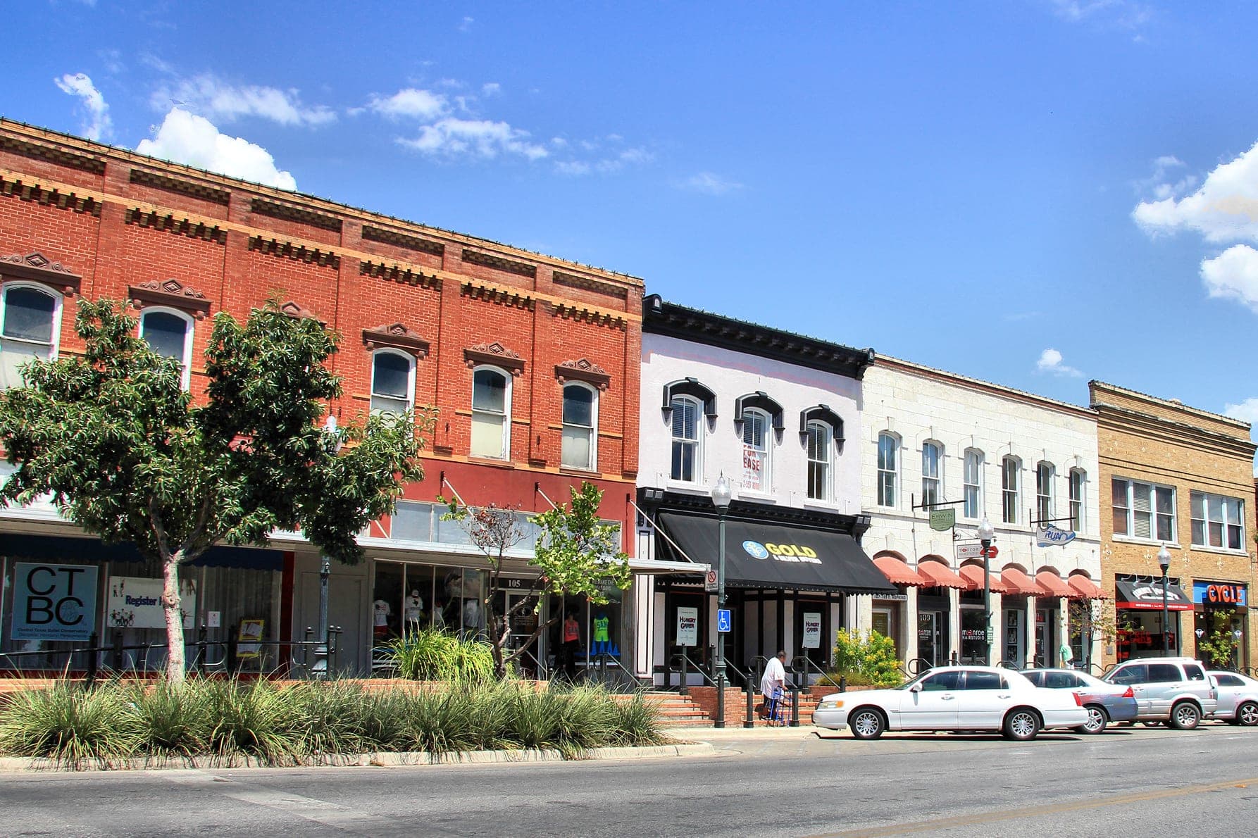 A row of brick storefronts on a Central Texas main street